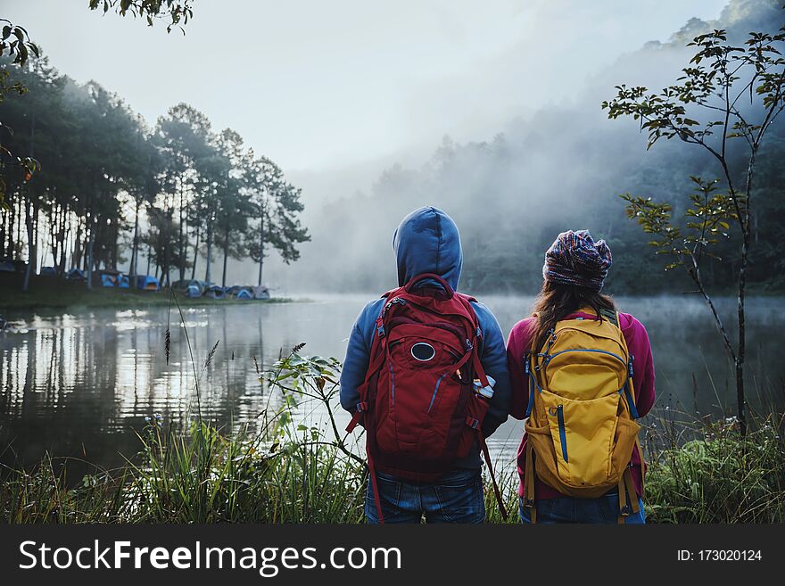 Couples who love to travel, take pictures Beatiful nature at Pang ung lake and pine forest at Mae Hong Son in Thailand.