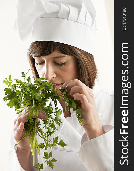 Female Chef Smelling Parsley