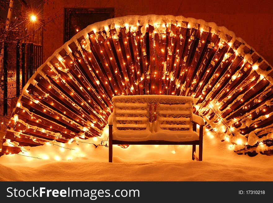 Wooden garden bench in Christmas Eve