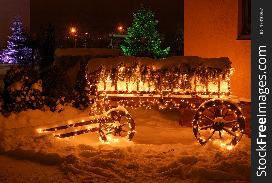 Wooden cart decorated with Christmas garland. Wooden cart decorated with Christmas garland