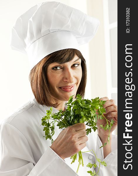 Cheerful Female Chef With Parsley