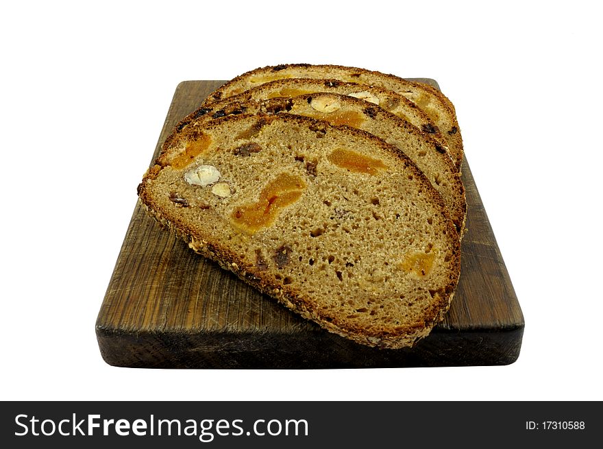 Whole wheat bread on a chopping board isolated on white