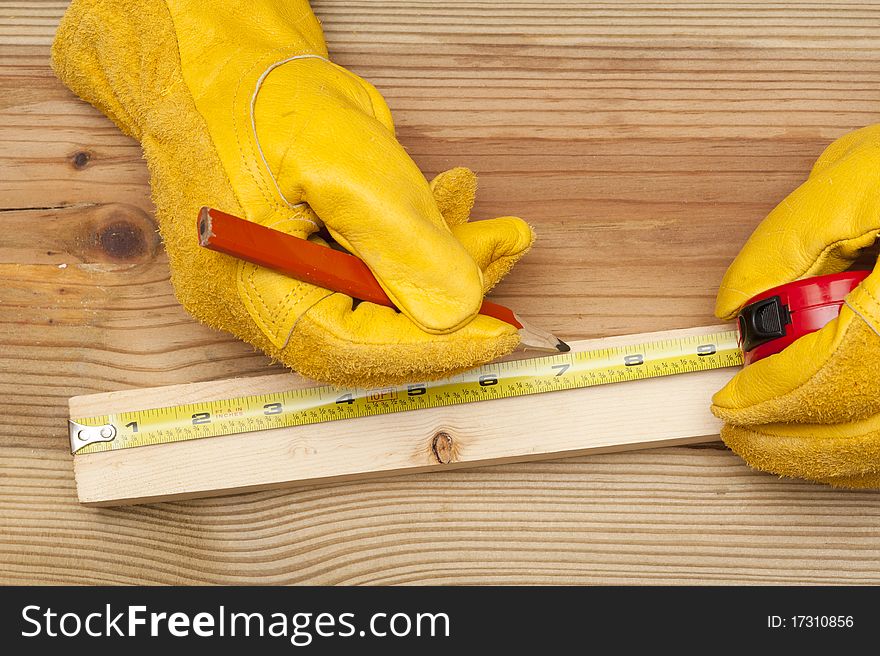 The worker makes a marking in meter