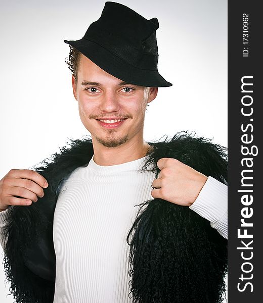 Trendy young man closed into the fur vest. Trendy young man closed into the fur vest