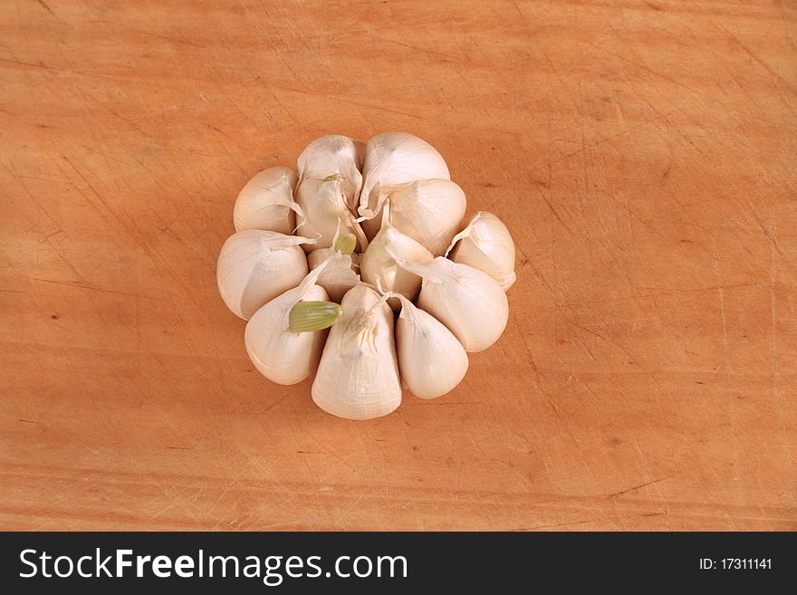 Over head garlic bulb image on wooden board