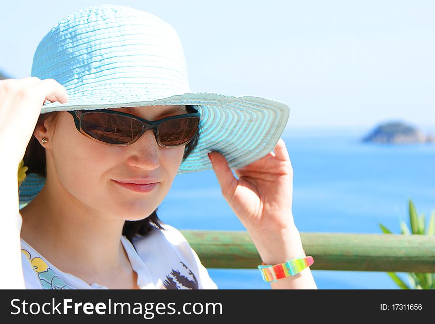Young Woman In Hat And Sunglasses