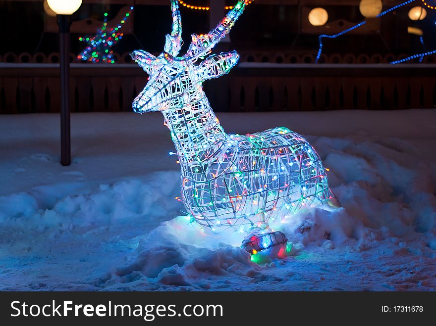 Glowing reindeer made of wire and color light bulbs. Glowing reindeer made of wire and color light bulbs