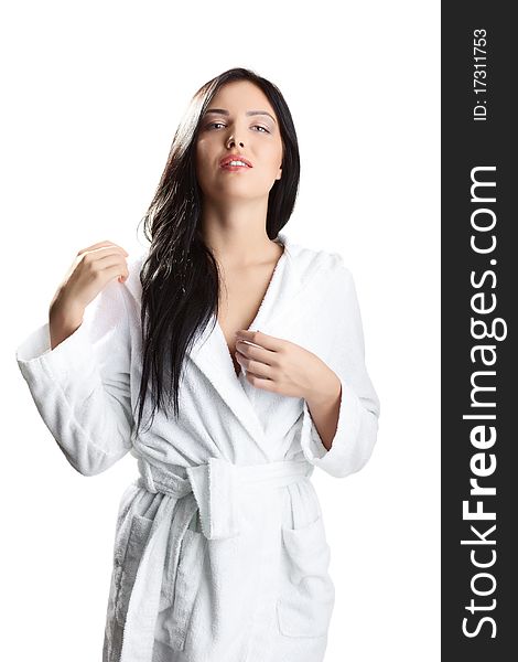 Portrait of fresh and beautiful brunette woman on white background wearing white bathrobe. Portrait of fresh and beautiful brunette woman on white background wearing white bathrobe