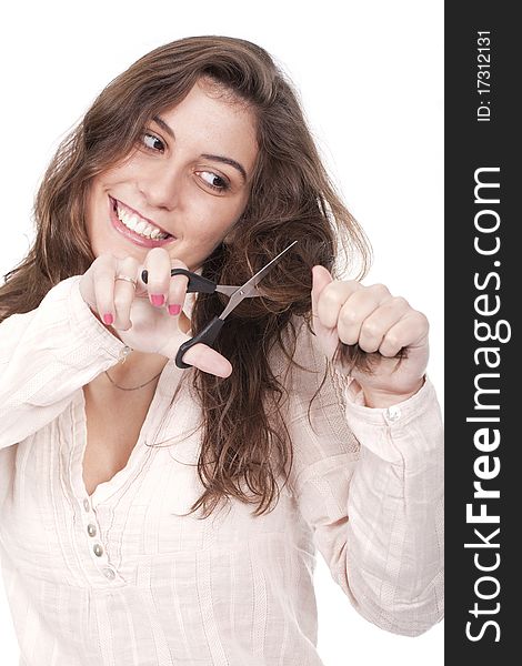 A young woman with a scissors trying to cut her hair. A young woman with a scissors trying to cut her hair