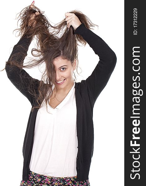 A young girl having fun and pulling her long hair. A young girl having fun and pulling her long hair