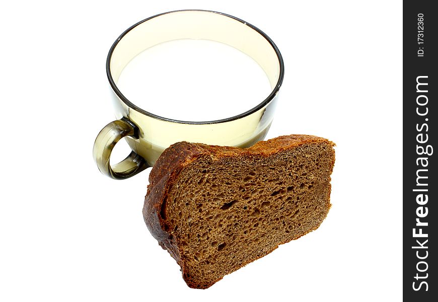 Black bread with milk in a mug on the white isolated background
