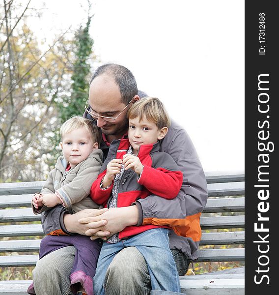 Father and two children outdoors