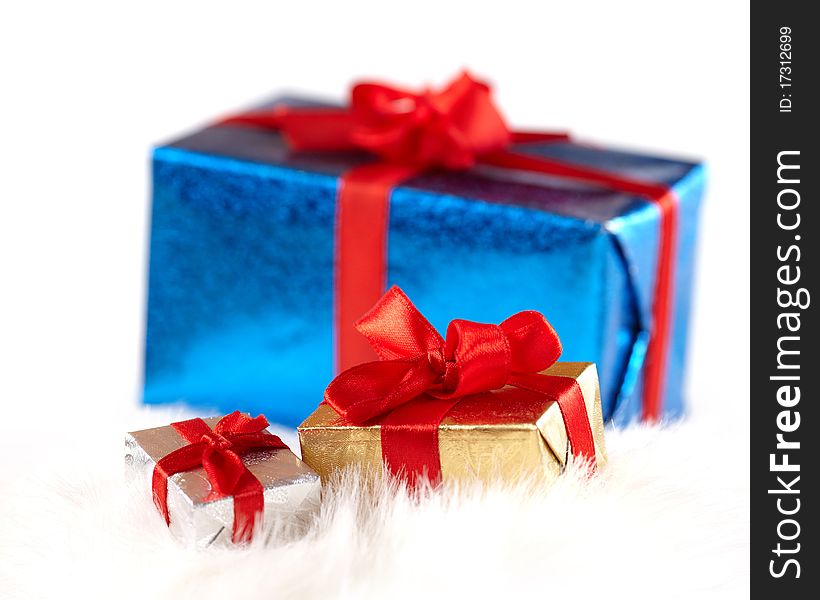 Small gift boxes over a big one isolated on white