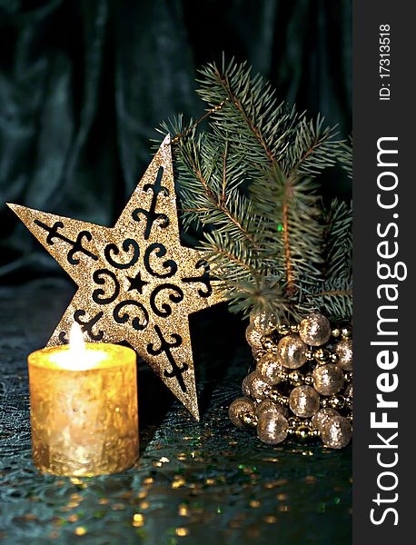 Christmas composition, candle, fir branch and star on a green background. Christmas composition, candle, fir branch and star on a green background.