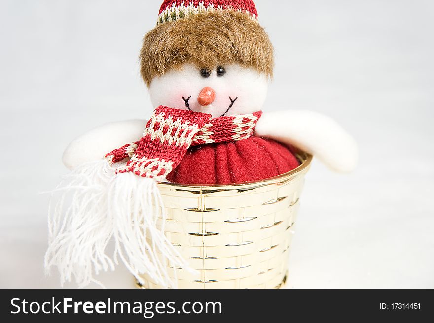 Snow man toy in a golden box decoration isolated