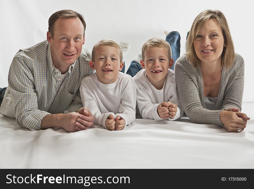 Young happy family with two identical twins