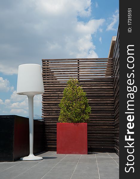 Floor lamp setting at a hotel roof under blue sky