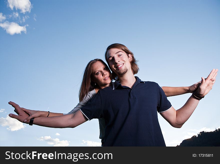 Young couple in love with blue sky in the background. Young couple in love with blue sky in the background
