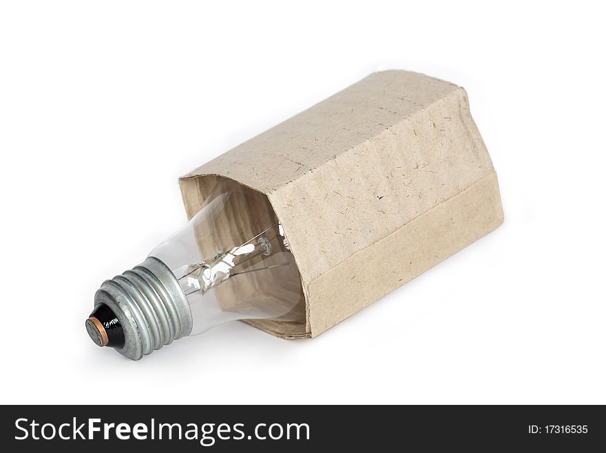 Light bulb in cardboard package isolated on white background. Clipping path is included. Light bulb in cardboard package isolated on white background. Clipping path is included