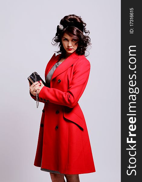 Beautiful young woman in retro coat