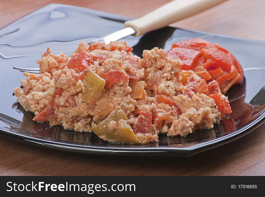 Scrambled eggs with pepper and fork
