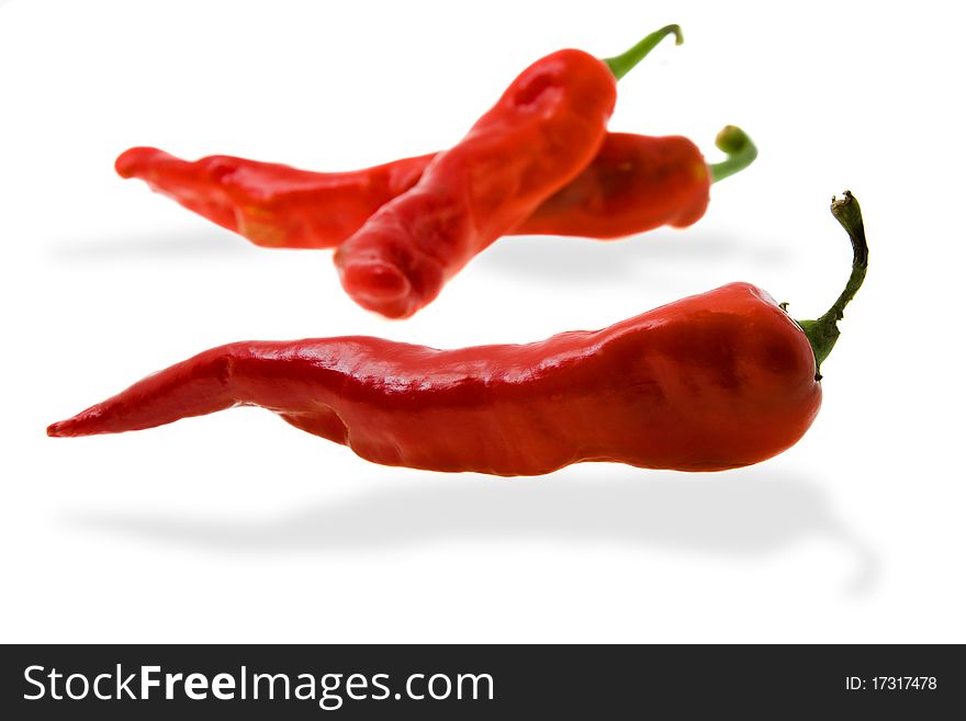 Some red pepper (two lie on a back background, with shades on a white background). Some red pepper (two lie on a back background, with shades on a white background)