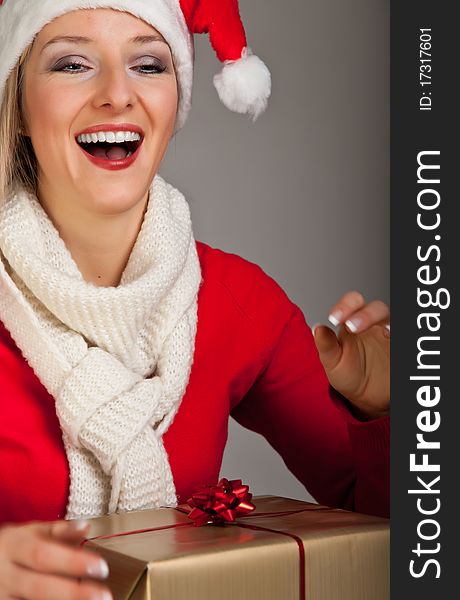 Woman in santa hat with christmas presents isolated on white background. Woman in santa hat with christmas presents isolated on white background