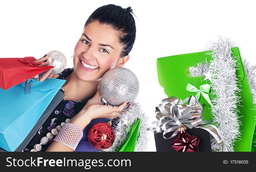 Happy girl with christmas decorations and bags, isolated. Happy girl with christmas decorations and bags, isolated