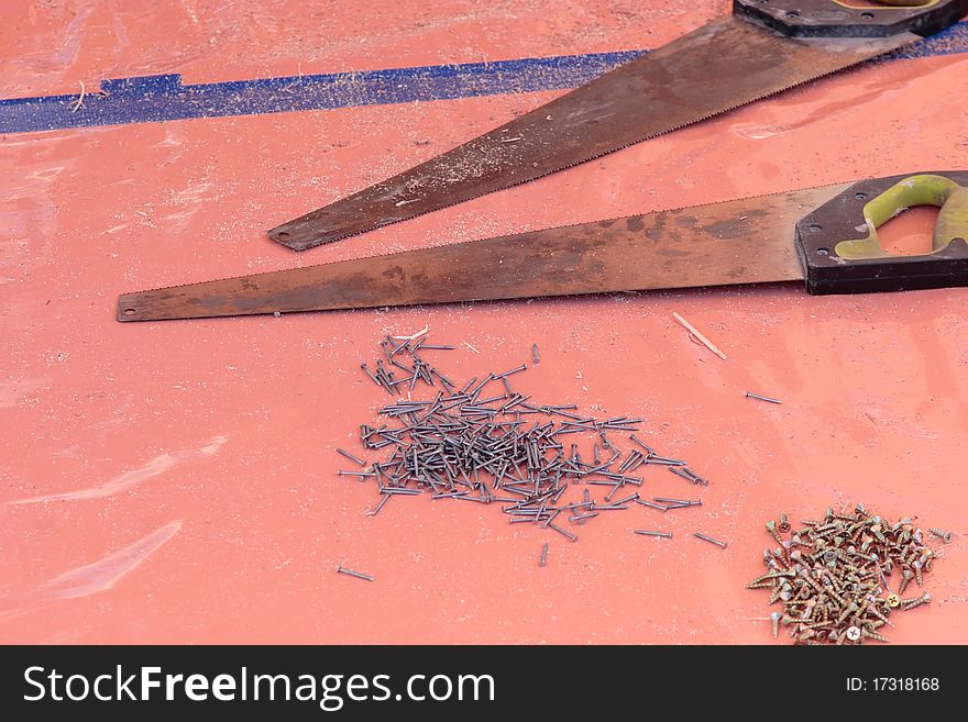 Saws nails and screws on a drop sheet. Saws nails and screws on a drop sheet