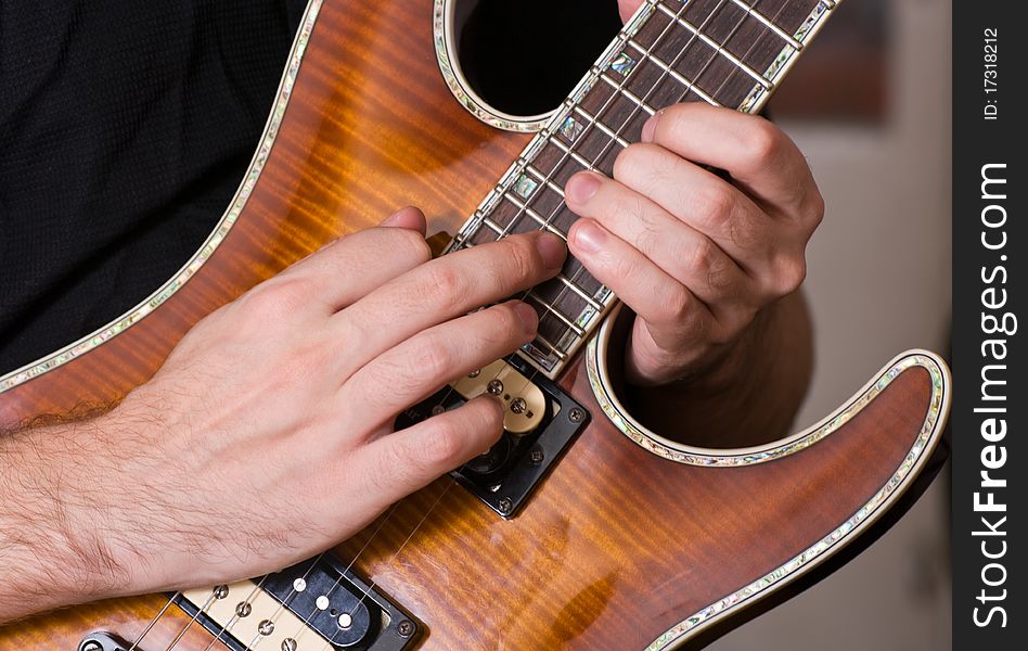 Closeup shot of hands playing on a guitar. Closeup shot of hands playing on a guitar