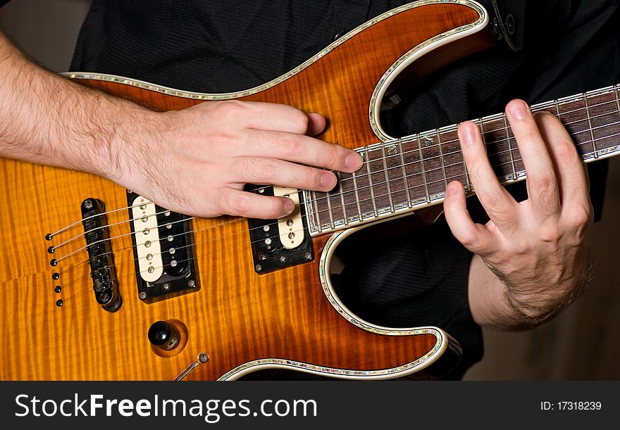 Closeup shot of hands playing on a guitar. Closeup shot of hands playing on a guitar