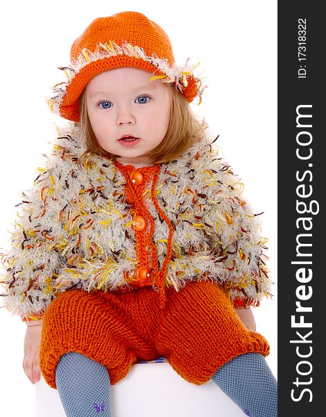 Little girl in orange hat smiling at camera on white background. Little girl in orange hat smiling at camera on white background