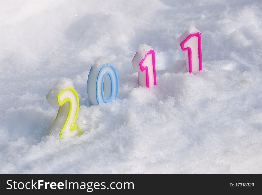 Candles representing the 2011 figures buried in the snow. Candles representing the 2011 figures buried in the snow
