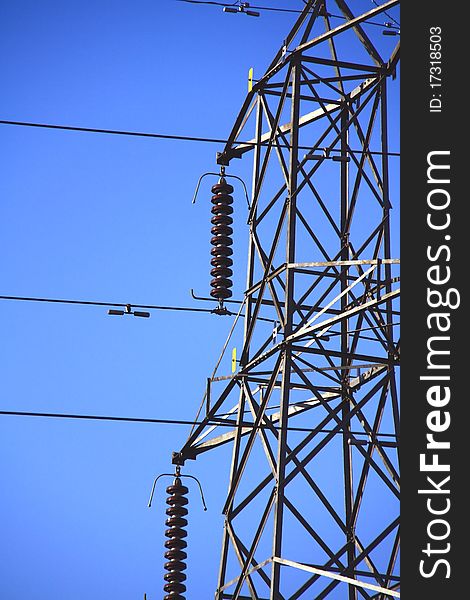 A close up picture of power lines with blue sky in the background. A close up picture of power lines with blue sky in the background