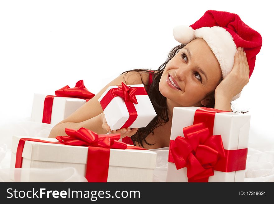 Beautiful sexy girl wearing santa hat with many gift boxes over white. Beautiful sexy girl wearing santa hat with many gift boxes over white