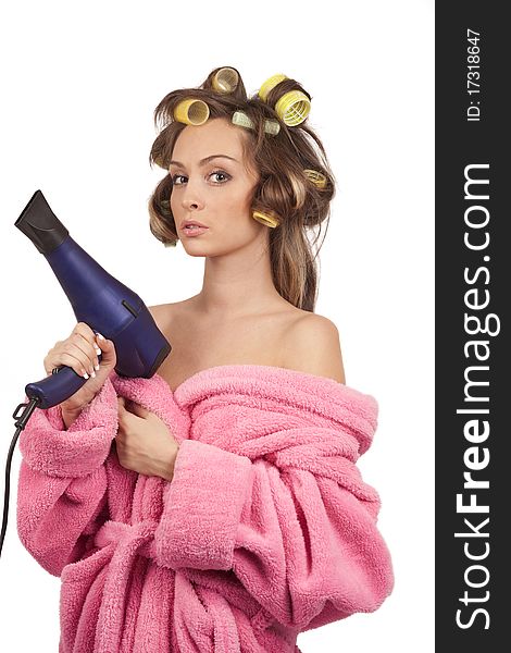 Girl in pink dressing gown with blue hairdryer