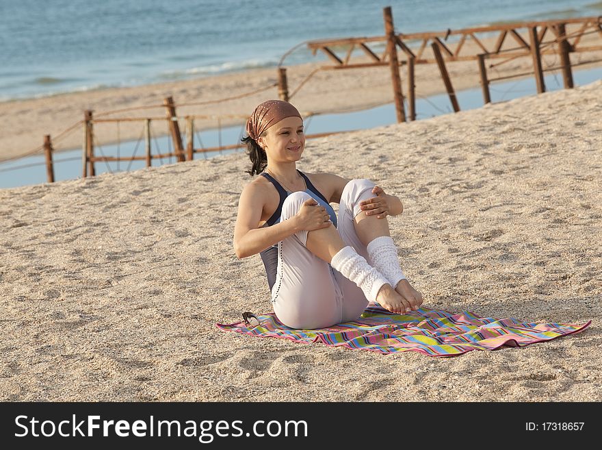 Young girl training at the sea shore. Young girl training at the sea shore