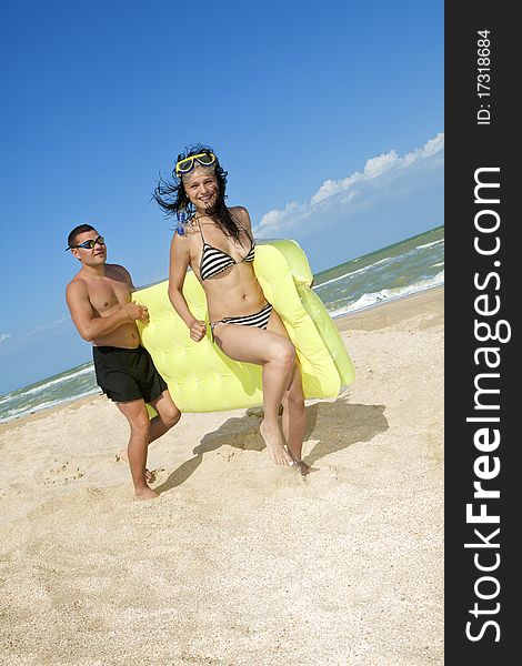 Romantic couple with an inflatable beach mattress