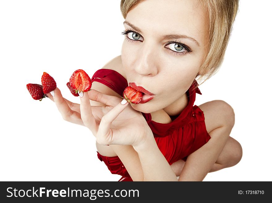 young woman with red strawberries picked on fingertips isolated on white background