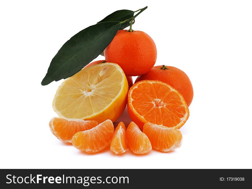 Tangerines and lemon with leaves on white background