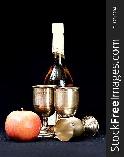 Apples,wine glass and bottle on a black  background