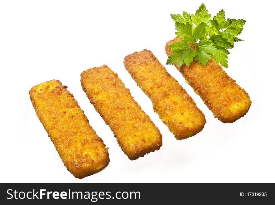 Four fish sticks isolated on white with some parsley