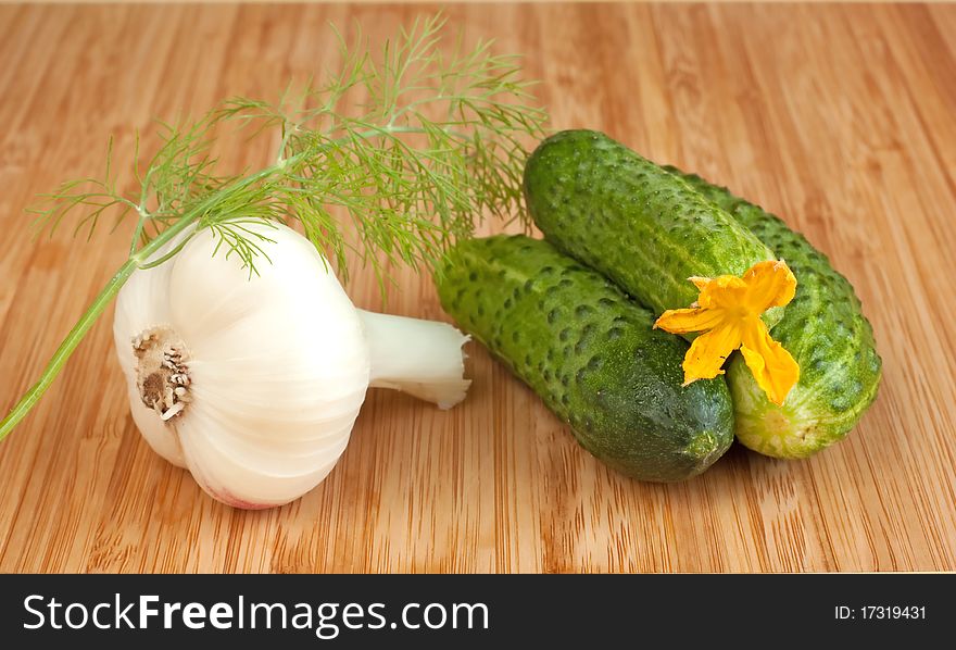 Cucumbers, and garlic on cutting board