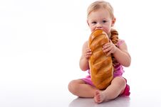 Baby Biting A Loaf Of Bread In Roll Beads Royalty Free Stock Images