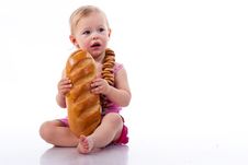 Baby Holding A Loaf Of Bread In Roll Beads Royalty Free Stock Image