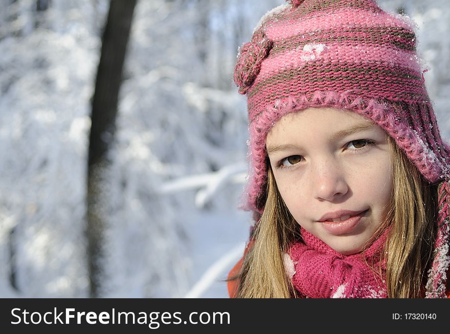 Funny girl posing in winter season, snow on branches in background. Funny girl posing in winter season, snow on branches in background