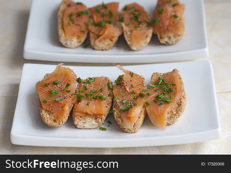 Swedish crisp bread topped with smoked salmon and chives. Swedish crisp bread topped with smoked salmon and chives
