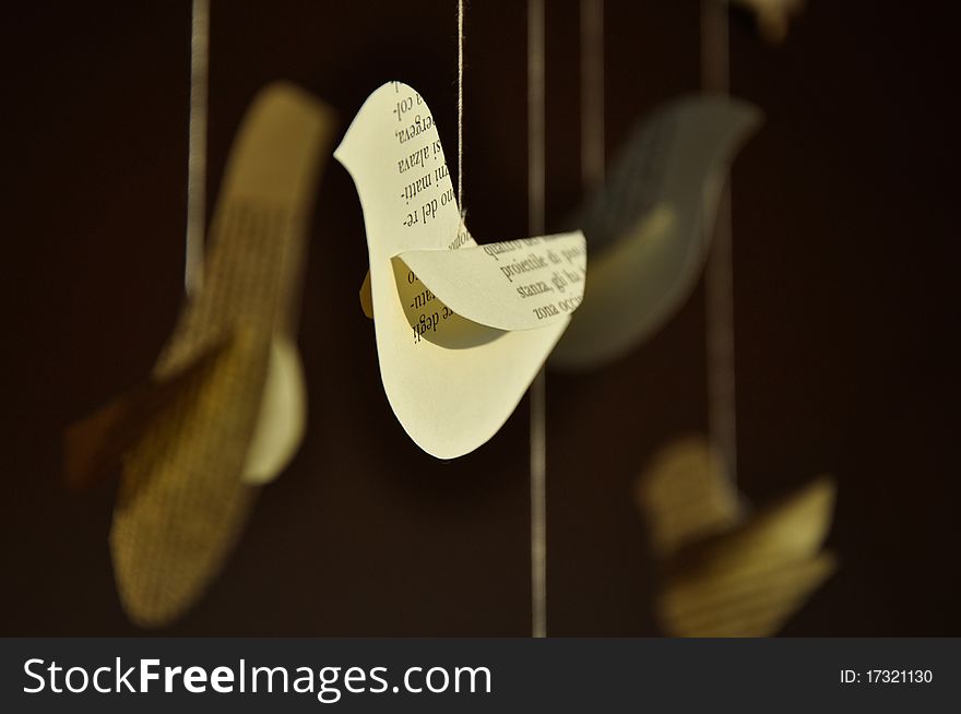 Decorative paper birds in front of a window