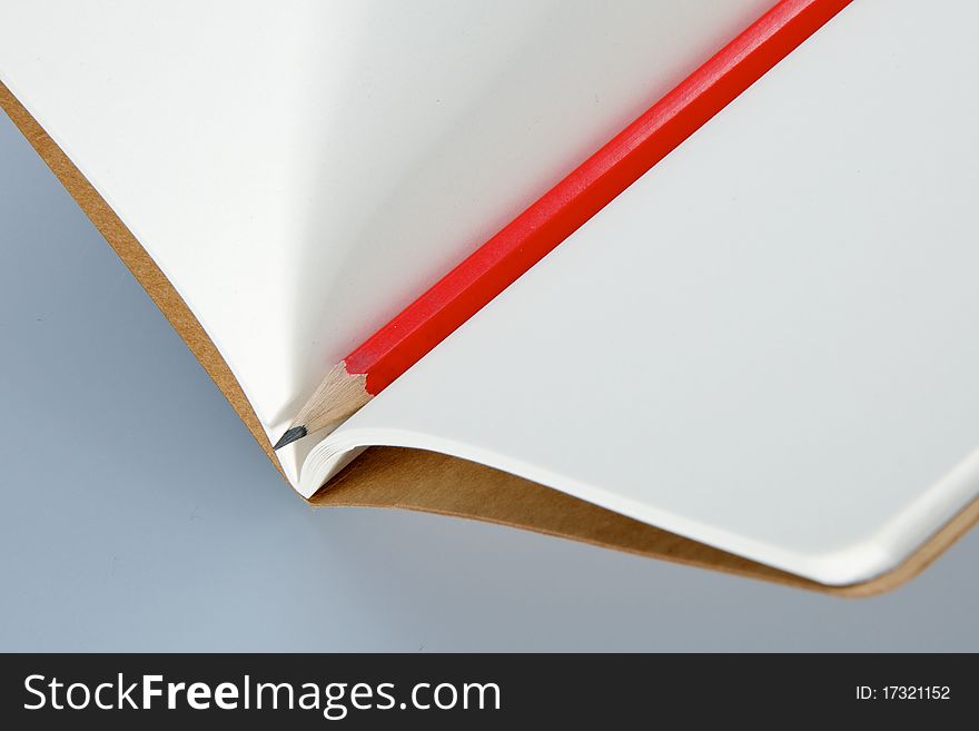 Blank notebook with a sharp red pencil. Blank notebook with a sharp red pencil
