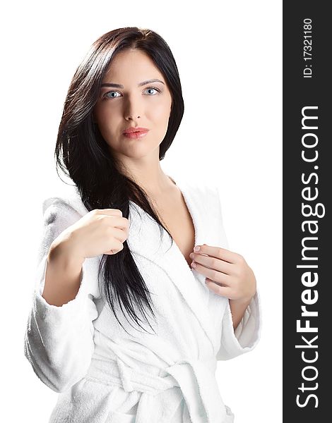 Portrait of fresh and beautiful brunette woman on white background wearing white bathrobe. Portrait of fresh and beautiful brunette woman on white background wearing white bathrobe